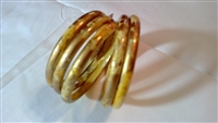 Lady's gold splattered ivory multi layer bangles.