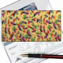 Lenticular checkbook cover with purple egg plant with green and red leaves on a yellow background, depth