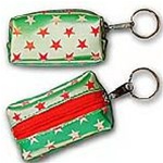 Lenticular purse key chain with white and red stars on a green background, color changing flip