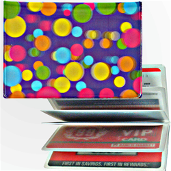 Lenticular credit card ID holder with pink, yellow, blue, and green balls on a purple background, depth