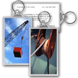 Lenticular acrylic key chain with custom design, tall crane lifts a heavy box from the ground, flip