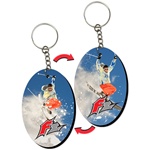 Lenticular foam key chain with oval shaped, snow skiier launches off a mountain into the crisp Alpine air, flip