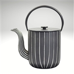 Image of the "Marage" cast iron teapot by Ja by Frieling. This teapot has a textured and handpainted exterior in a gold and mint circle pattern. The image shows the black handle.