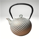 Image of the "Dim" cast iron teapot by Ja by Frieling. This teapot has a textured and handpainted exterior in a gold and mint circle pattern. The image shows the black handle.