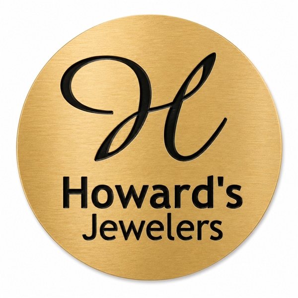 Custom engraved FlexiBrass round disc in gold finish with black logo engraving and adhesive backing
