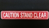 "Caution Stand Clear" - â€‹1 5/8"H x 9"W - (One Sided) - â€‹ANSI 156.10 COMPLIANT - (NABCO)