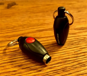 small, football shaped, black punch cutter with a red button