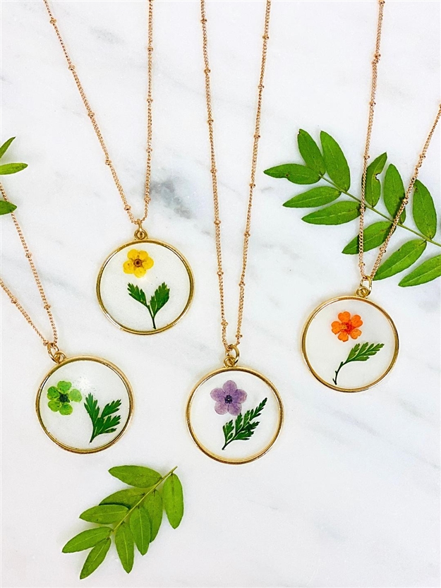 Four different Mirajo Jewelry Blossoms Necklace on white background