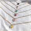 Six different Mirajo Jewelry butterfly necklaces on a white cloth