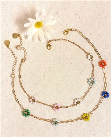 two different Mirajo Jewelry daisy necklaces on light background