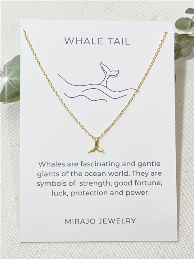 One Mirajo Jewelry whale tail necklace on a white cloth