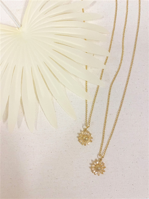 Two Mirajo Jewelry wildflower necklaces on white cloth