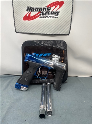 A Dye MXR electronic paintball marker in the Arctic Fade colorway. The marker fades from polished blue to polished silver from the barrel to the back of the marker.