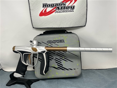 This listing is for a used Empire SYX electronic paintball marker. The marker is dust silver with dust bronze accents. The gun has some cosmetic wear, but is still in very good condition overall.