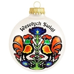 Festive, colorful art complements the Polish Christmas greeting. Christmas customs of Poland are featured on the reverse side of this exclusive 3" tall glass ornament.  Roosters are a classic Polish folk theme featured here in a gorgeous paper cut art des