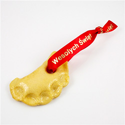 These are handmade in Michigan by a Polish farmer's wife.  They are made just like real pierogi only baked and coated with shellac as a sealer.  We add the red and gold Wesolych Swiat ribbon to hang on a tree or on a stand.