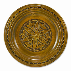 Hand Made in Southern Poland Polish wooden plates are made from Linden wood in the mountain region of southern Poland called Podhale. The plates are cut and shaped on a lathe by hand. The floral designs are burned into the wood before staining and varnish