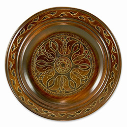 Polish wooden plates are made from Linden wood in the mountain region of southern Poland called Podhale. The plates are cut and shaped on a lathe by hand. The floral designs are burned into the wood before staining and varnishing. All the flowers are surr