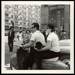 Couple on a motorcycle in downtown Warsaw in 1967. Historical Black and White Photo Postcard.