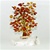 The leaves of this bonsai style tree are made with real polished amber stones attached to branches and trunk of twisted brass wire. The tree sits atop a piece of the finest Polish marble called "Marianna". No two trees are alike and amber shades vary. Bra