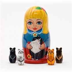 A winsome blond maid and her feline friend decorate this outer doll -- but wait, there's a surprise inside! When you open the doll, 4 different miniature cat figurines can be found. A delight for cat lovers.