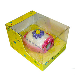 Medium sugar panoramic Easter Egg with a miniature sugar Easter chick sitting on green sugar grass inside.   Floral design on the outside, surrounded by a decorative band of colored icing.