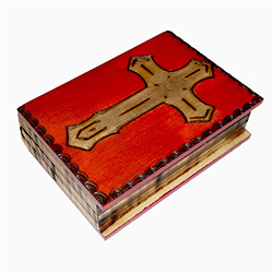 Prominent Cross on top of lid. Box is carved and shaped like a book. Sides are carved to resemble pages. Top is mahogany finish. Hinge lid.