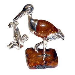 Honey amber and sterling silver stork carrying a new born baby in his beak.  Exquisite hand craftsmanship.  Unique and very beautiful.