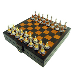 Exquisitely beautiful hand-crafted sterling silver and amber chess set.  Pieces have black felt bottoms and have a nice weight and feel.  This set includes custom tooled-leather covered wooden case