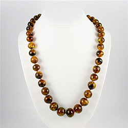 Natural Baltic amber necklace.  Knotted between each bead.  Bead size varies from .3" to .6" diameter.  Beautiful coloration.