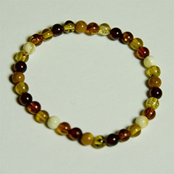 Dainty 5" - 13cm Bracelet composed of milky, honey, and cherry shades of round Baltic Amber beads.
Bead size 1/8" - .5cm
Cloth covered elastic band
Not for children under 4 due to small parts