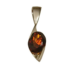 Multi-facted honey amber suspended in a stylized silver pendant resembling a clef note.