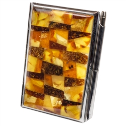 Unique and beautifully hand-crafted amber mosaic combination business card and note pad holder with pen.  Artistic mosaic of varied colored and shaped amber pieces applied to the top of a stainless steel business card holder. Spring clip to hold down busi