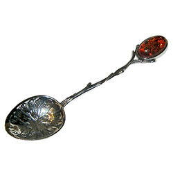 Very elegant sterling silver demitasse spoon (smaller than a teaspoon), with the handle topped with a oval amber stone.  Beautiful workmanship in the bowl of the spoon and the handle.