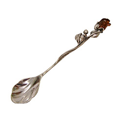 Very elegant sterling silver spoon with the handle topped with a rose carved from  amber.  Beautiful workmanship both with the silver handle and carved rose.