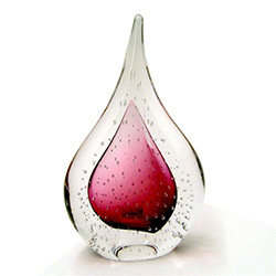 Two-sided art glass paperweight, with a gorgeous cranberry interior core, surrounded by flurry of bubbles, in a classic teardrop shape.  Each piece is hand blown and hand finished in Poland.  Made with the highest quality craftsmanship and hand-signed by