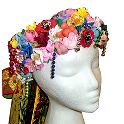 Beautiful handmade flowered headpiece for the Slask costume with 30" long attached set of ribbons.  Ribbon set is easy to detach if required.  The intricate designs on the ribbons are woven rather than printed for a rather stunning appearance.