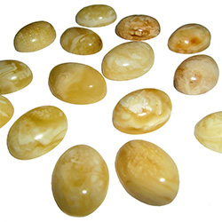 Approx .5" x .62" x .25" thick - 10mm x 15mm x 5mm thick.  These are oval domed amber cabochons.  Price is per piece.