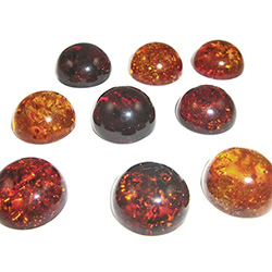 Approx .625" dia x .312" thick - 15mm x 7mm thick.  These are round domed amber cabochons.  Price is per piece.
