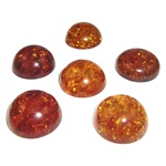Approx .75" x .31" thick - 20mm x 10mm thick.  These are round domed amber cabochons.  Price is per piece.