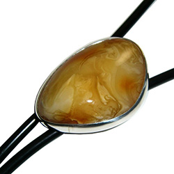 Beautiful black bolo tie with a large centerpiece of custard amber set in a sterling silver casing.  Silver tipped ends.