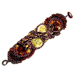 Bozena Przytocka is a designer of artistic amber jewelry based in Gdansk, Poland.   Here is a stunning example of her use of amber and brown material to create a beautiful and unique woven bracelet.  Includes faceted cognac amber beads.