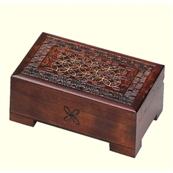 This dark box has a circular Celtic pattern with metal inlays and a detailed handcarved design on the lid. A removable drawer rests inside the box and the box has a footed base.