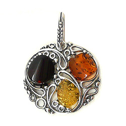 This is a stunning sterling silver pendant highlighting three amber stones.