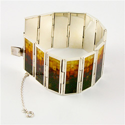 Hinged sterling silver cuff bracelet consists of 13 rectangular segments, inlaid with multi-color mosaic amber. The process to create this amber mosaic is quite unique.  See the video below.