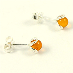 Honey amber spheres studs inside a simple Sterling Silver flower.  Stylish and unique earrings.