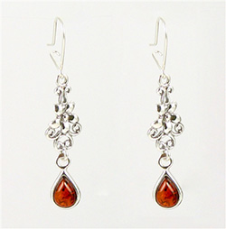 Honey amber tear drops dangling from a Sterling Silver floral design.  Stylish and unique earrings.