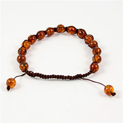 This fine macrame bracelet is made with cognac colored amber.  This bracelet includes dark brown cord and a slide clasp to fit most wrists.