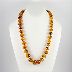 The beads on this beautiful necklace are circular shaped and are graduated in size from 3/8" long to the largest bead at 5/8" long.  As you can see from the photographs they are a stunning unique color.