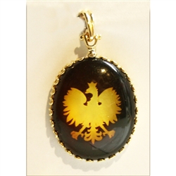 The Polish Eagle is etched on the back side of this clear amber cabochon.  Set in a frame and finding of 14 karat gold this is an exquisite piece of jewelry.